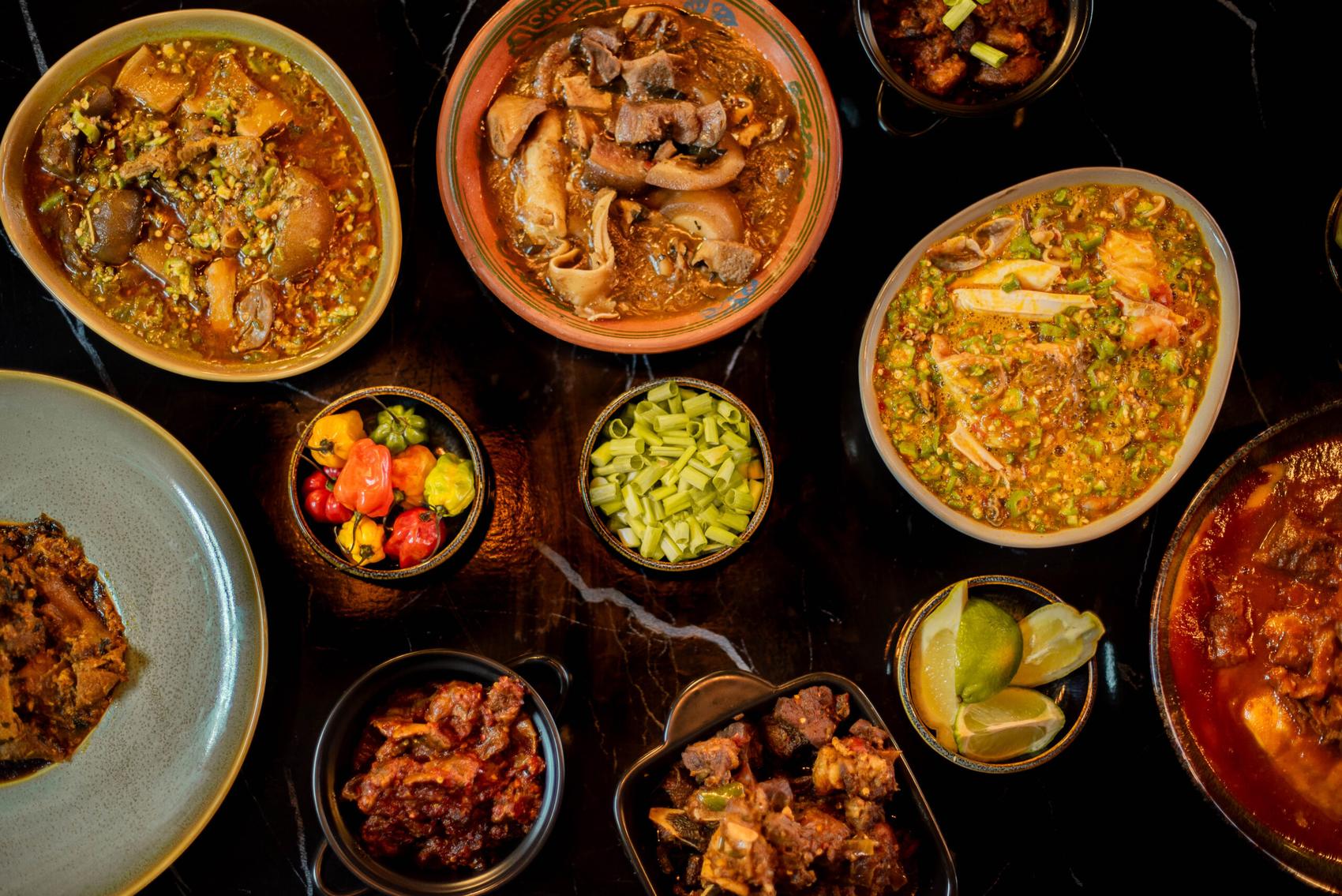 A large spread of dishes laid across a table
